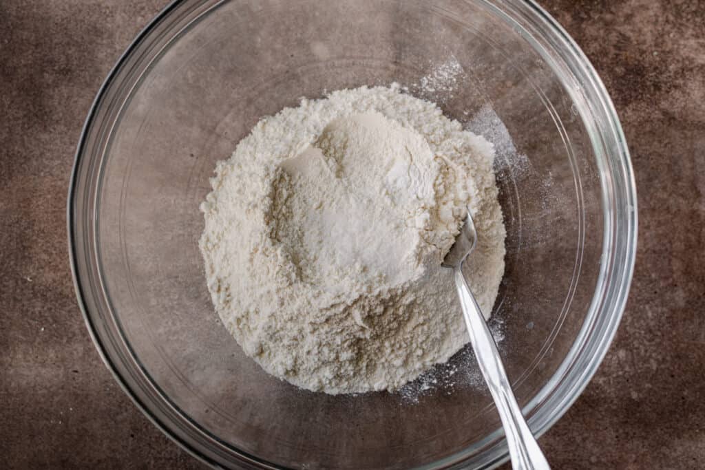 bowl of flour, salt, and baking powder with a fork