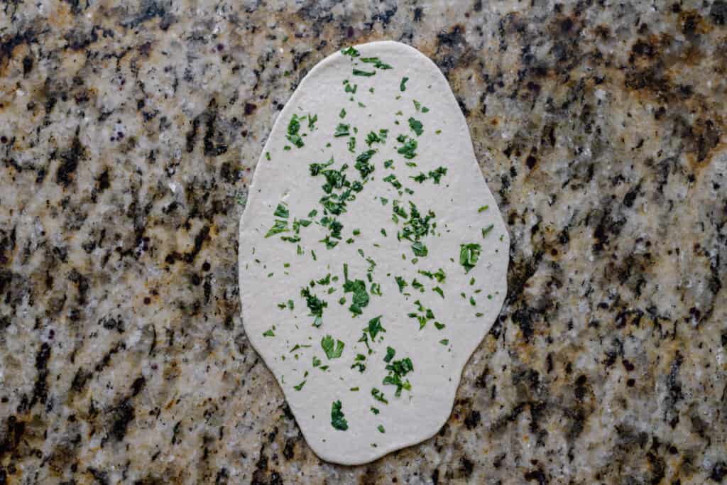 uncooked cilantro naan on counter
