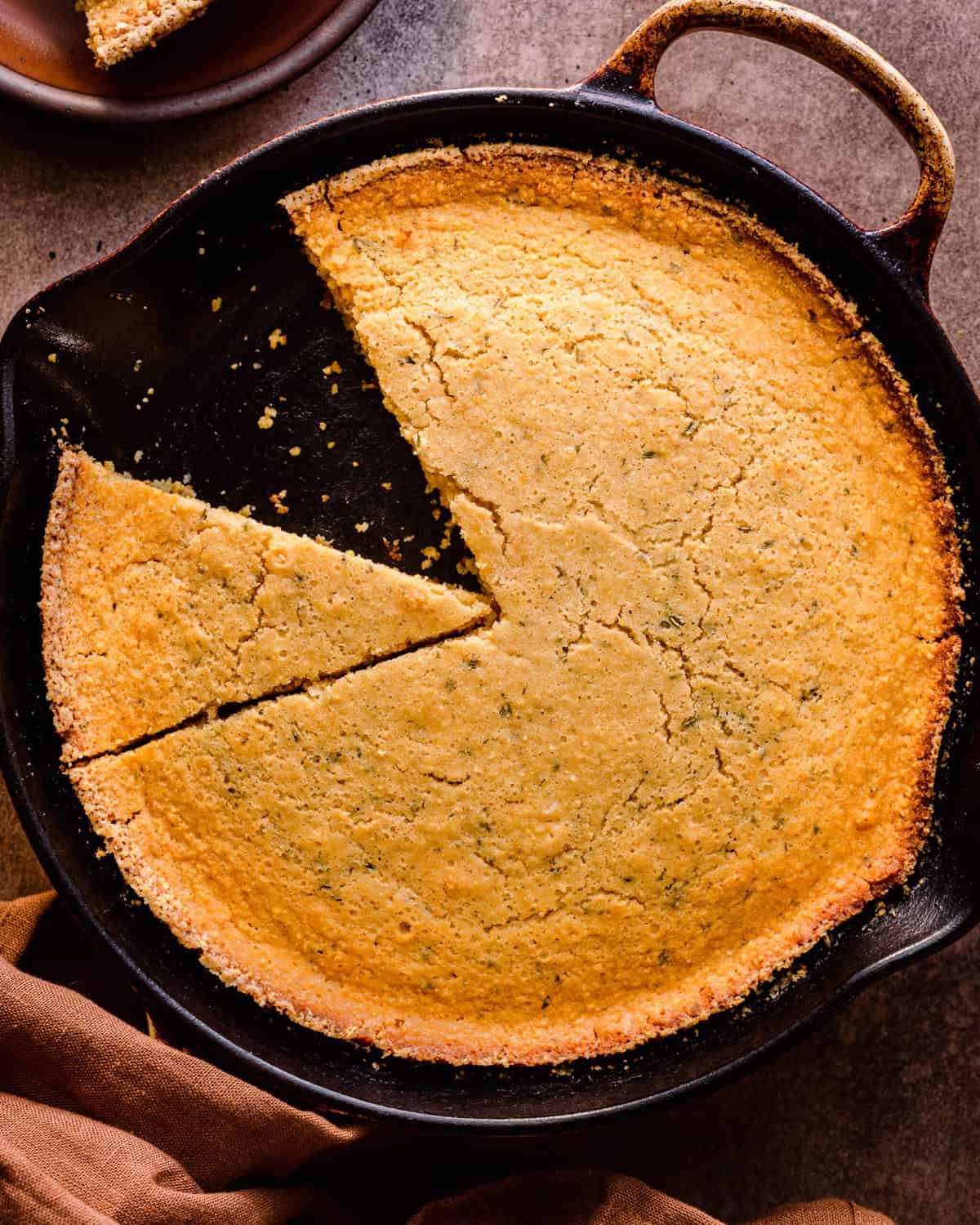 sliced vegan cornbread in cast iron skillet