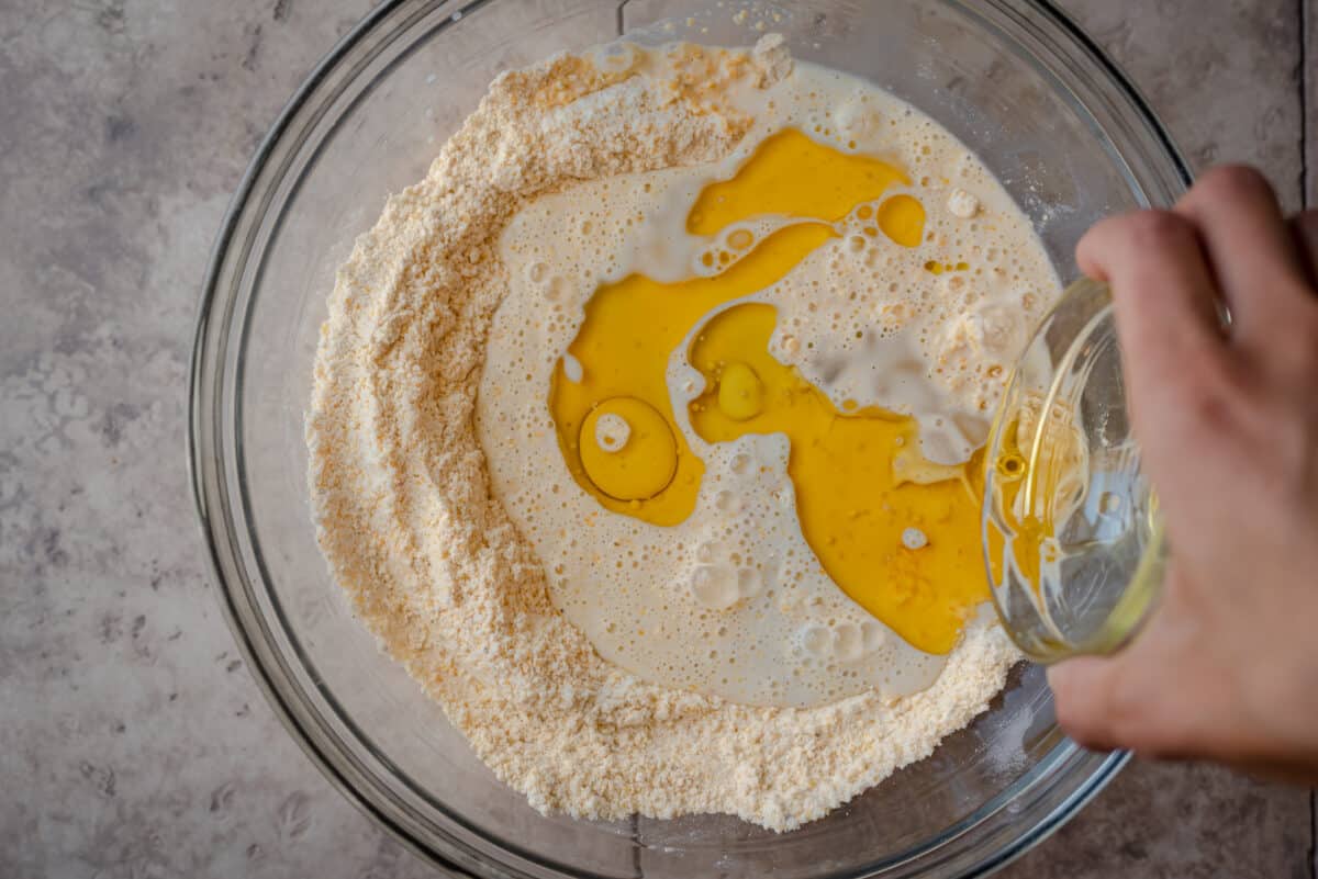 pouring melted butter into cornmeal batter
