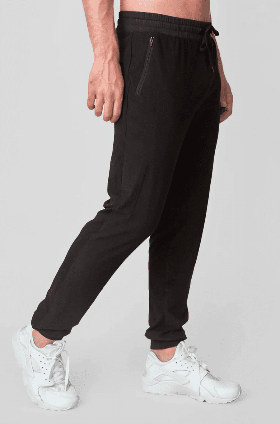 Man's bottom half wearing black joggers.