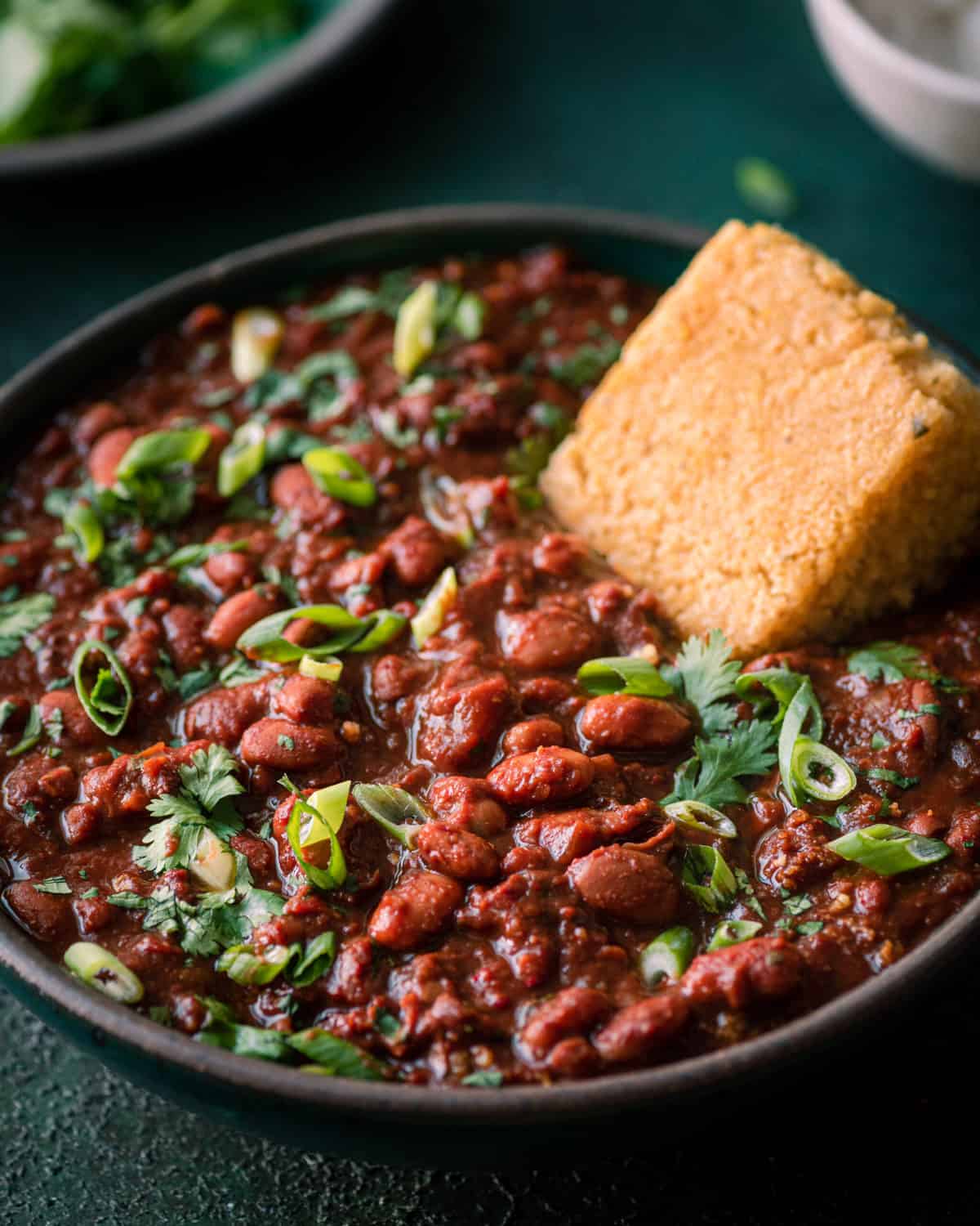 Bowl of vegan chili with a slice of cornbread.