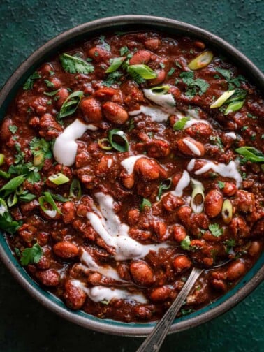 bowl of vegan chili with sour cream and cilantro