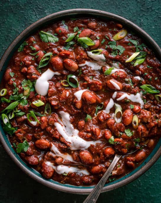 bowl of vegan chili with sour cream and cilantro
