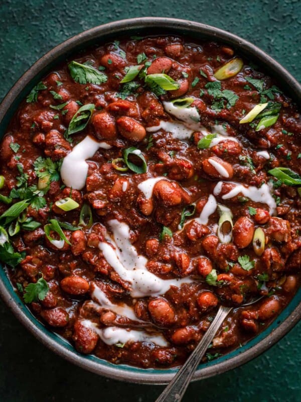 bowl of vegan chili with sour cream and cilantro