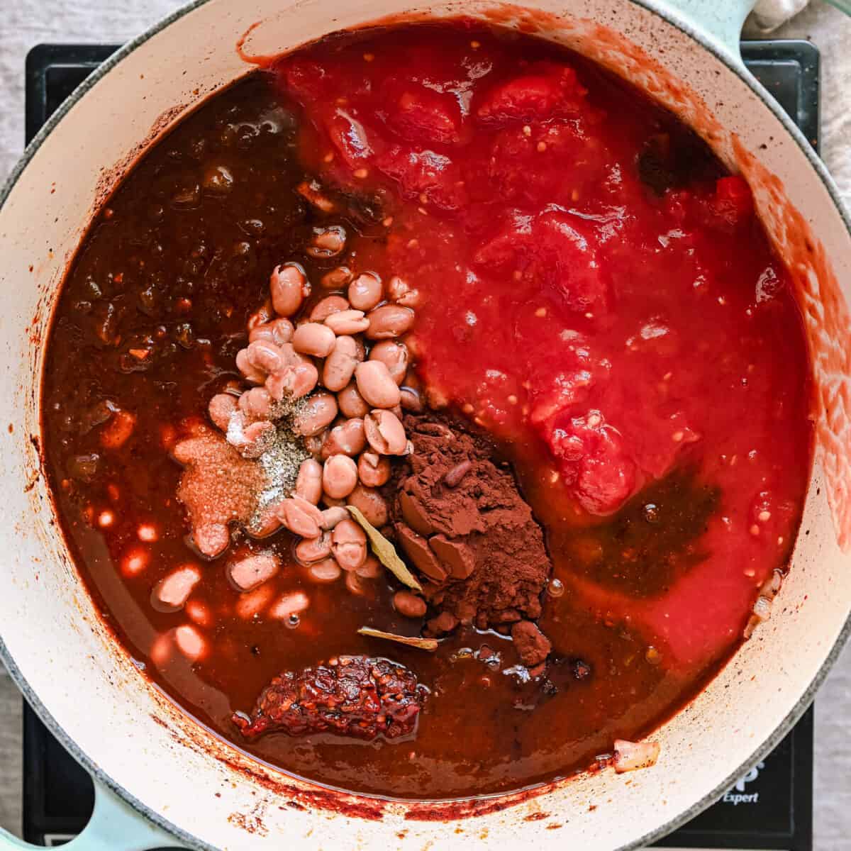 tomatoes, pinto beans, cocoa powder, chipotle peppers and bay leaves added to chili