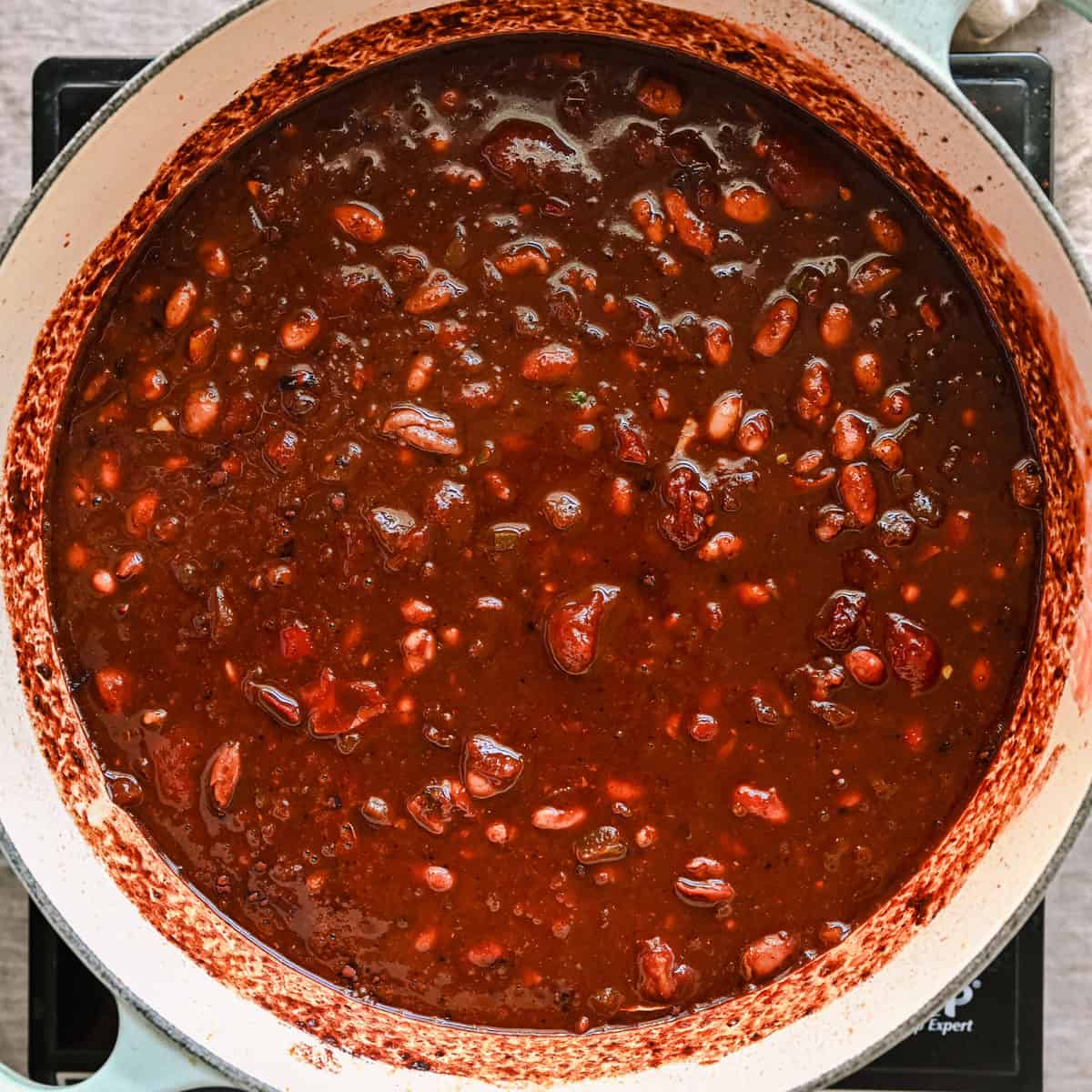 stirred chili ingredients in pot before being brought to a simmer.