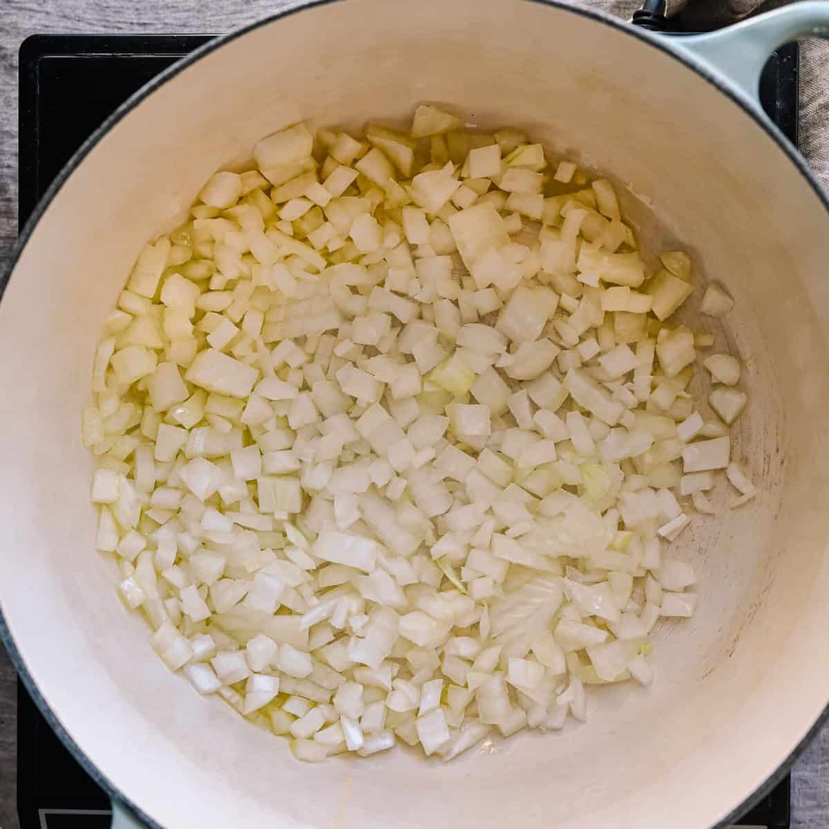 onions and oil cooking in a pot.