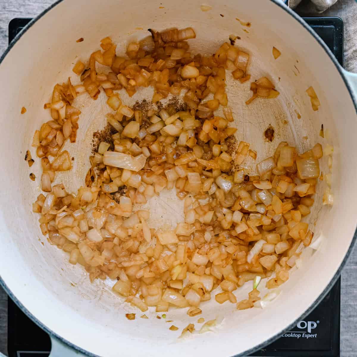golden brown onions sauteing in a pot.