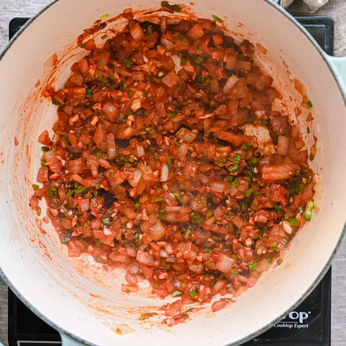 tomato paste stirred into onions in a dutch oven