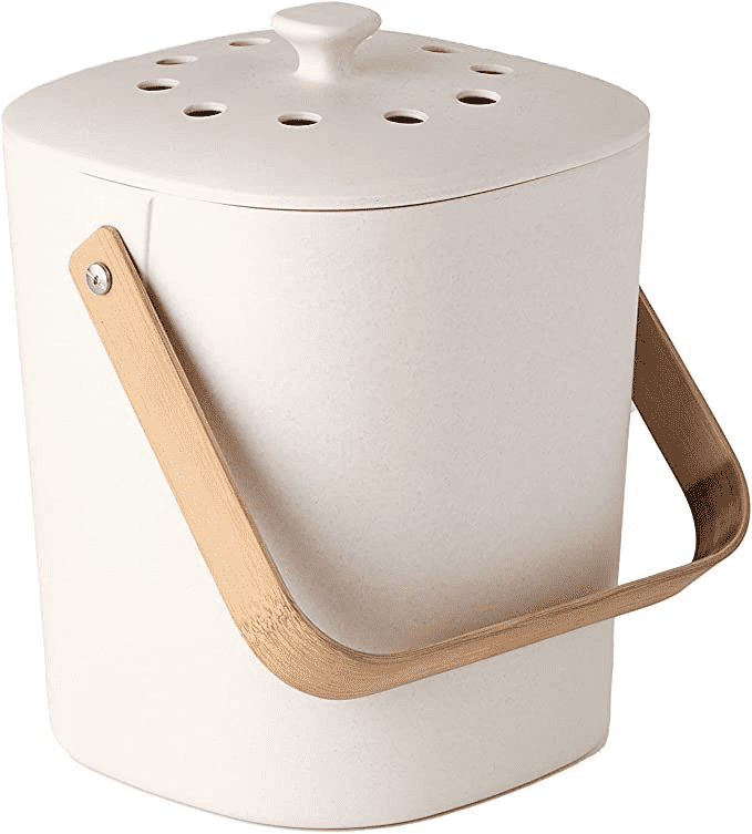 Tan tabletop food composter with white backdrop.