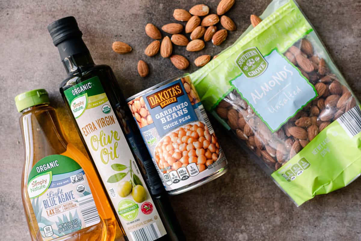 vegan pantry staples with agave nectar, olive oil, chickpeas, almonds
