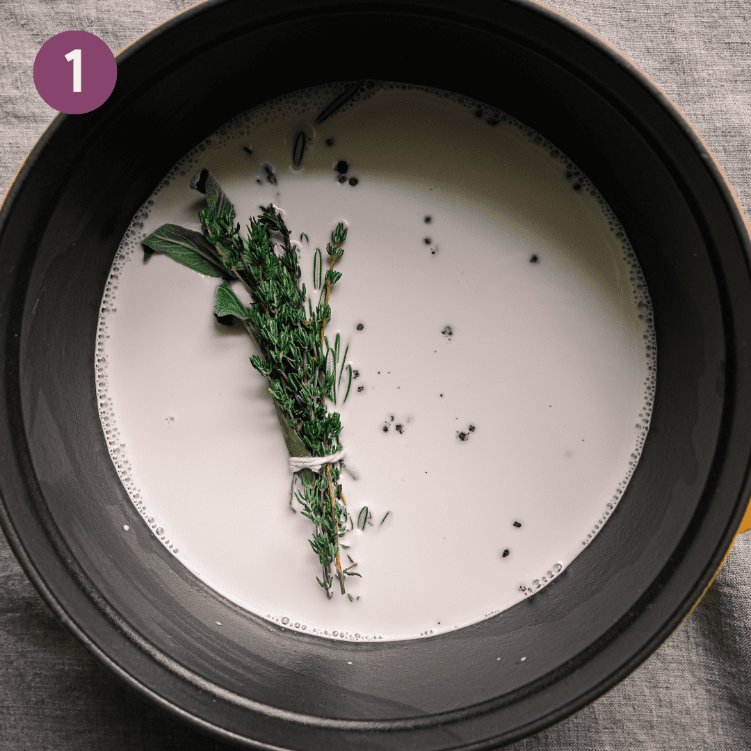bouquet garni of herbs in a saucepan of milk