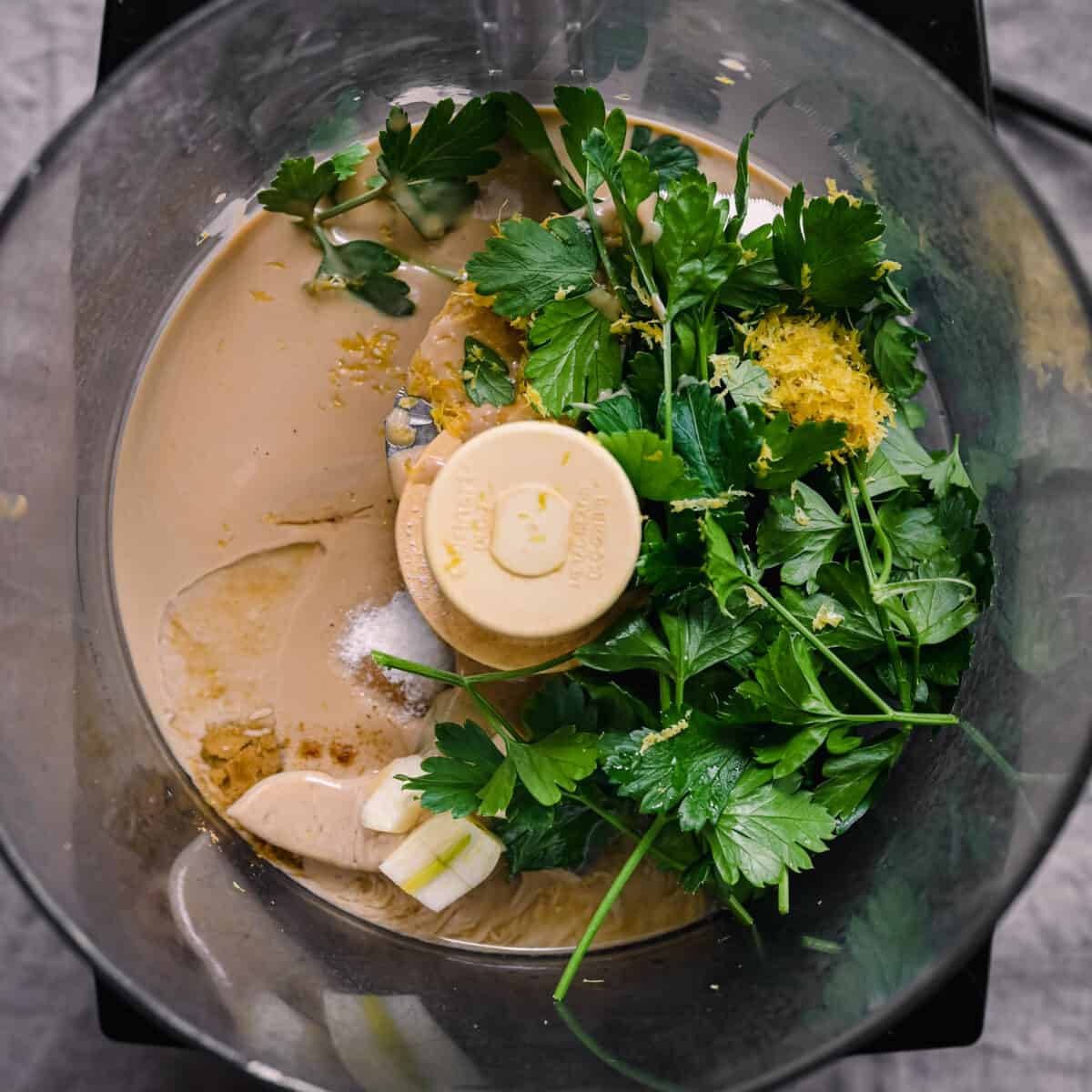 tahini, parsley, and lemon in food processor for tahini sauce