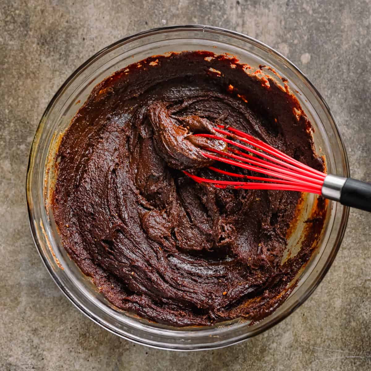 vegan fudge mixture in bowl with whisk