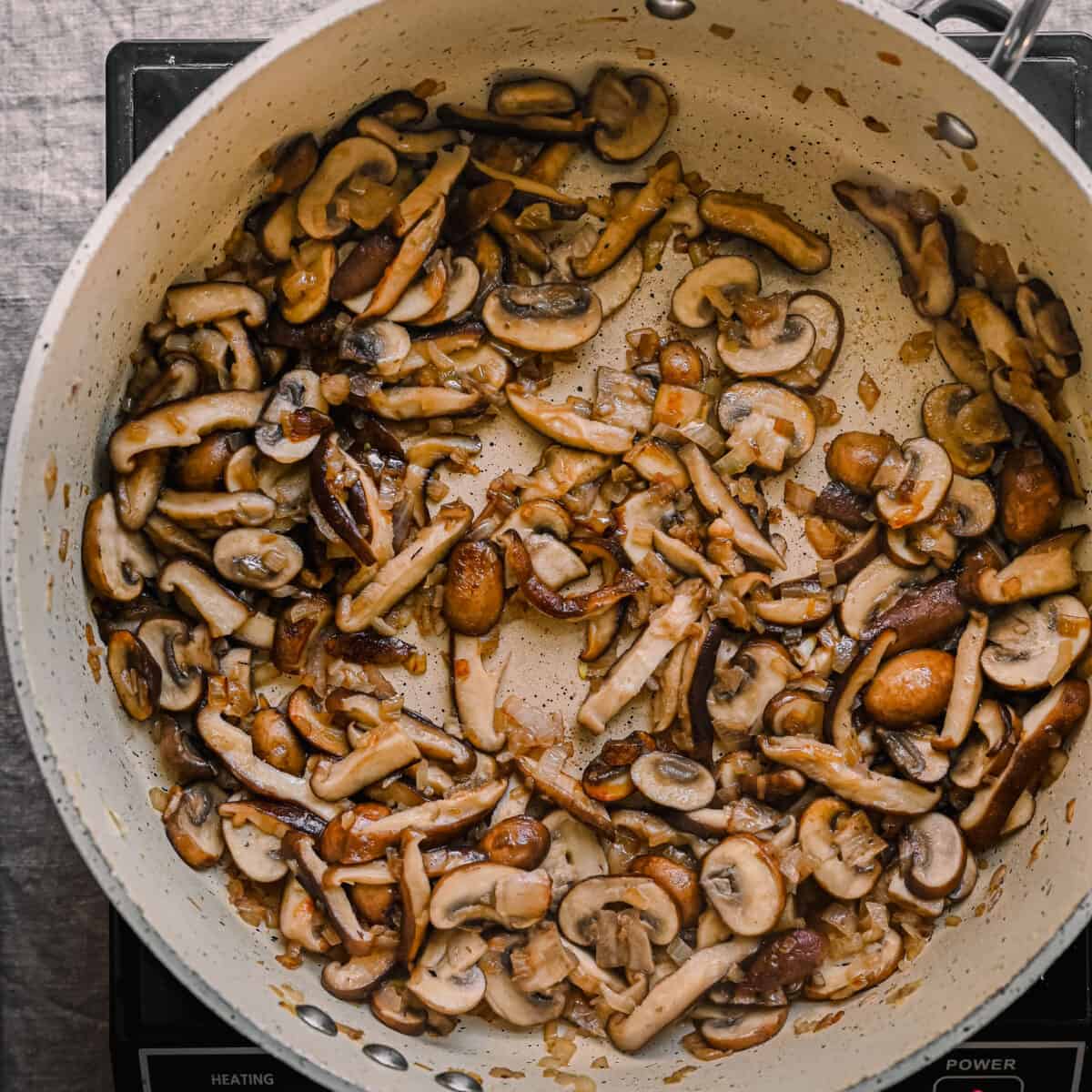 sauteing mushrooms until golden brown in a skillet