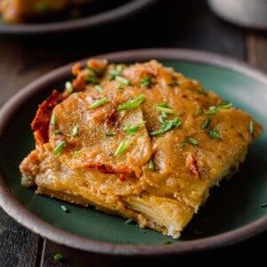 one square of scalloped potatoes on a small plate.