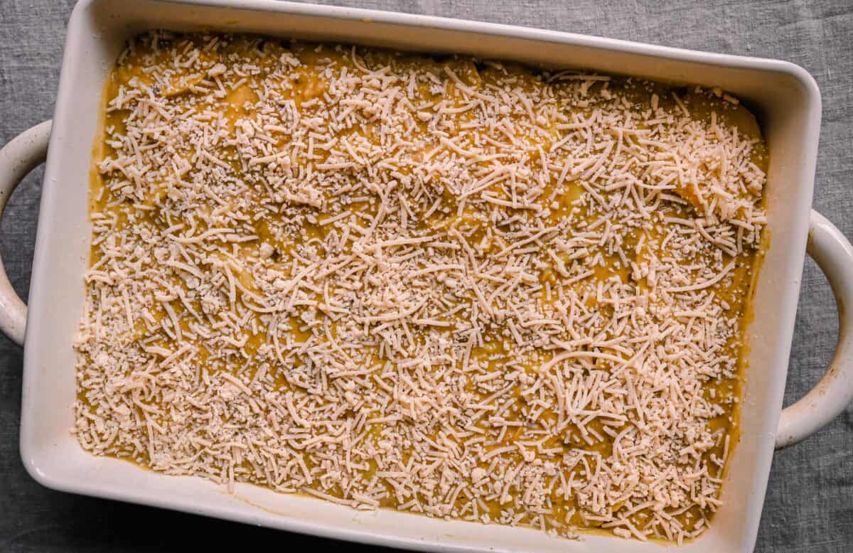 vegan parmesan on top of cheesy vegan scalloped potatoes