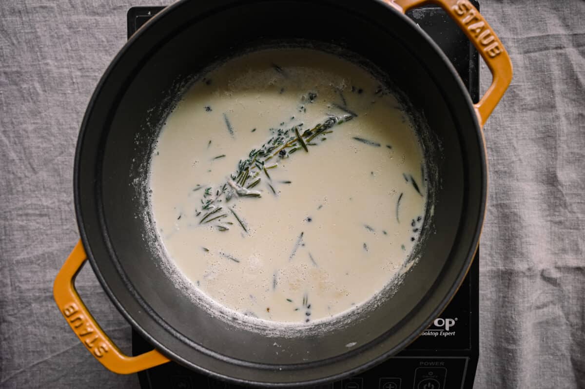herb-infused milk in a saucepan