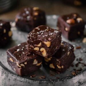 three squares of vegan fudge sitting on a pie tin