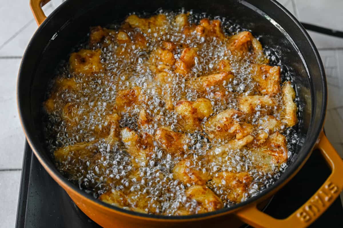 deep fried cauliflower sizzling in a pan of hot oil