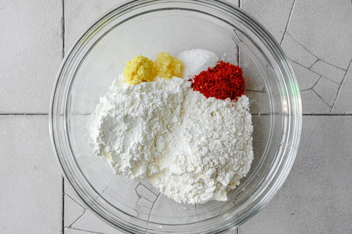 flour, cornstarch, garlic, ginger, and spices in bowl