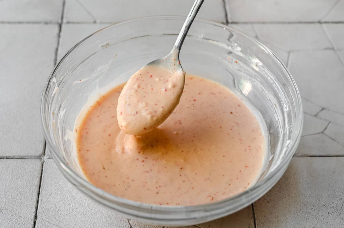 stirring cornstarch batter in glass bowl