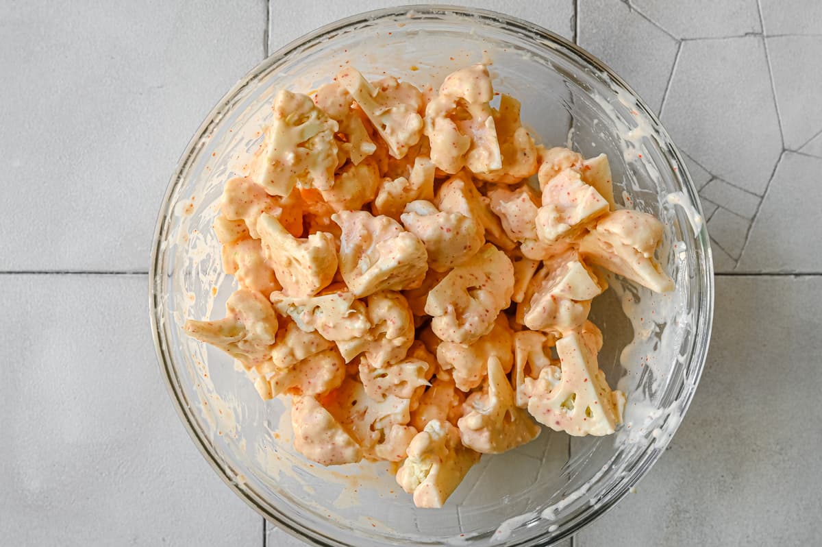 cauliflower florets coated in batter in bowl