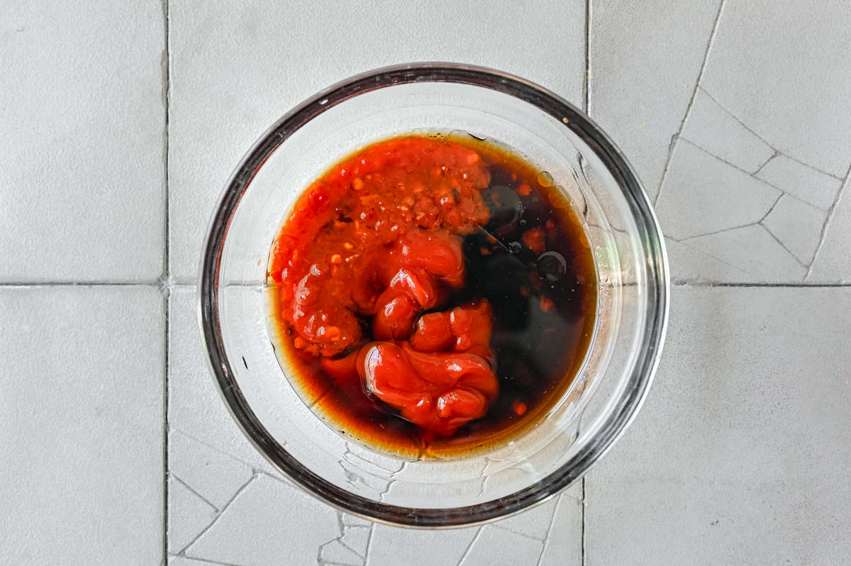 Manchurian sauce in bowl on white tile surface