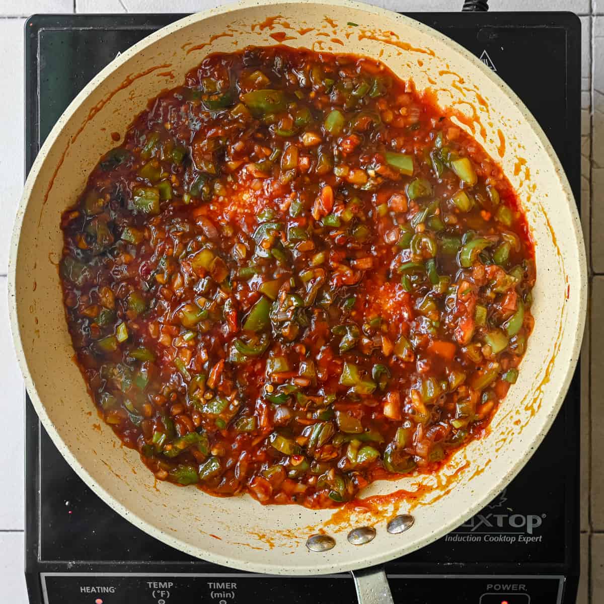 Manchurian sauce simmering in a frying pan