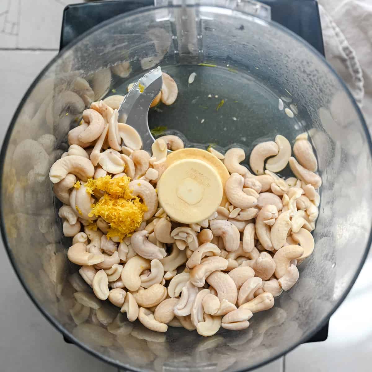 raw cashews, lemon zest, lemon juice and water in food processor bowl