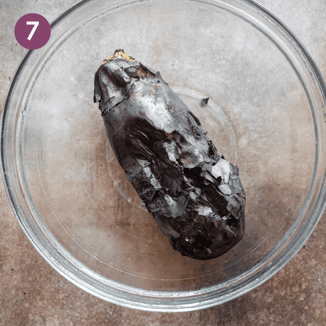 charred eggplant sitting in glass bowl.
