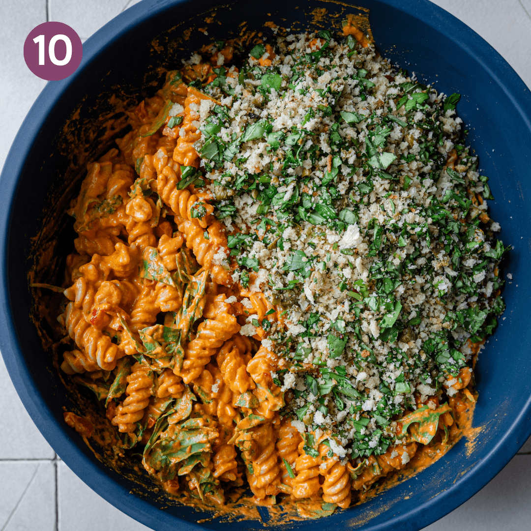 vegan pasta salad with roasted red pepper sauce, topped with basil bread crumb topping.