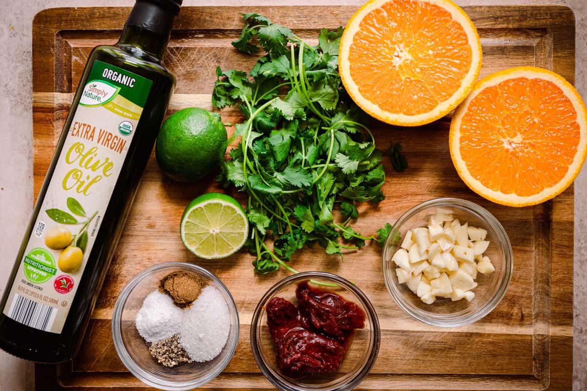 ingredients for chipotle-cilantro sauce on wooden cutting board.