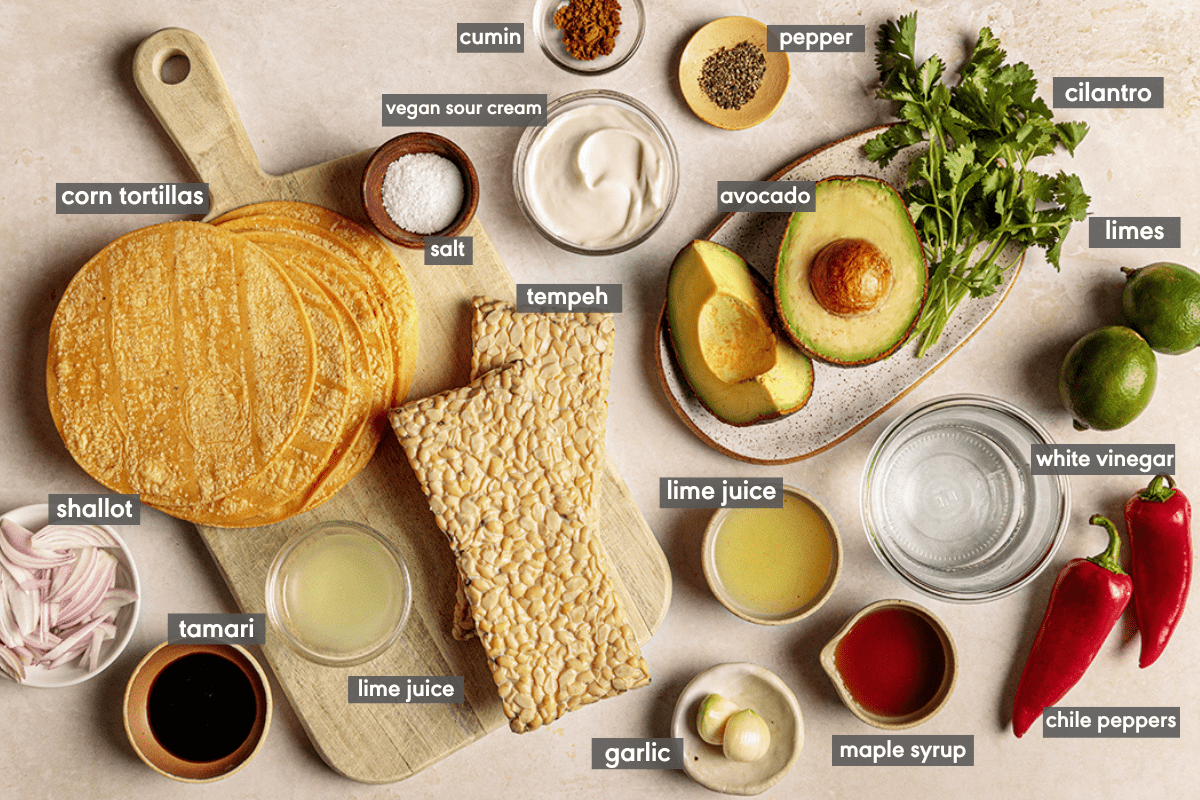 ingredients for tempeh tacos laid out on a board with ingredients labeled. 
