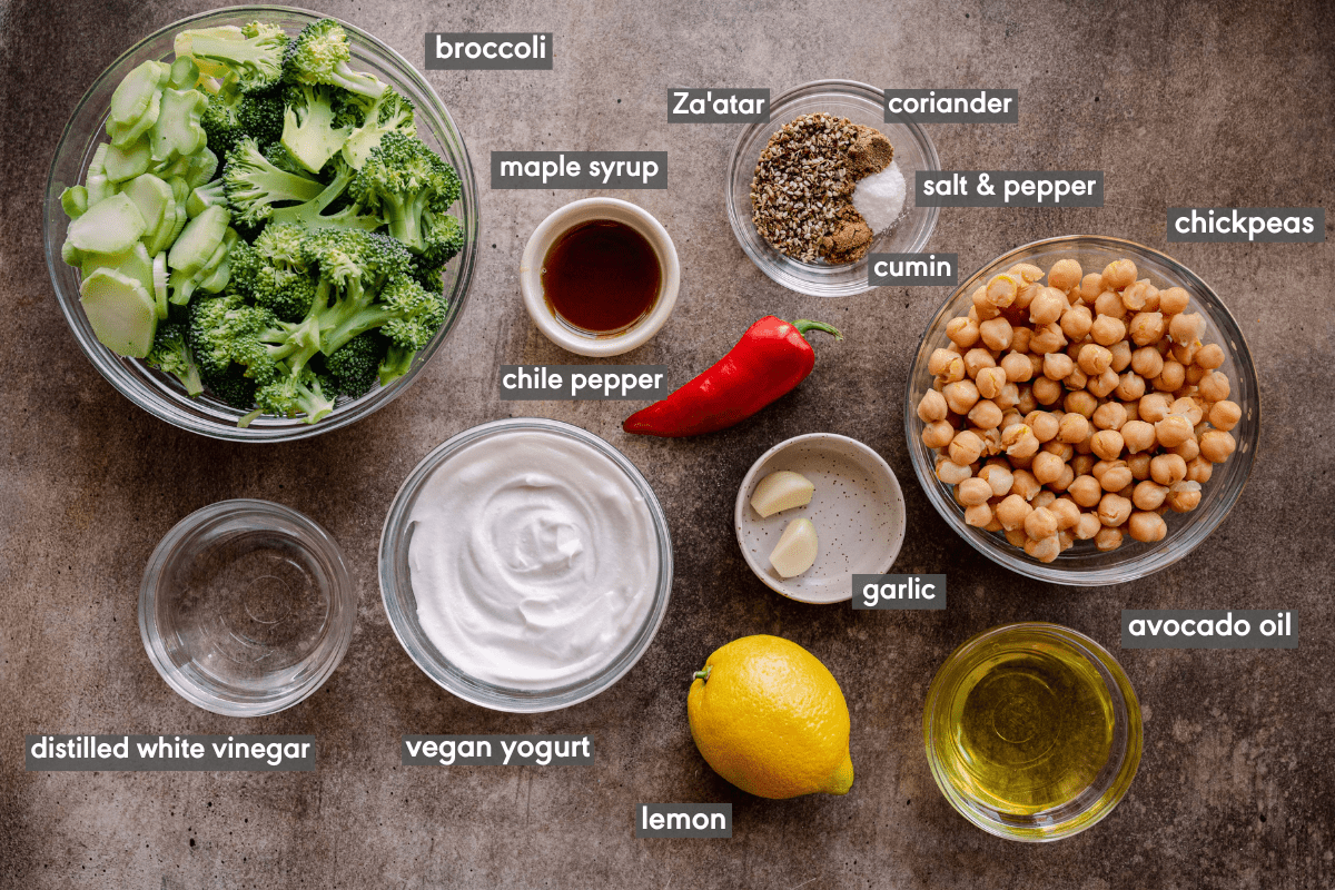 Ingredients for chickpeas and broccoli dish in separate bowls and labeled by ingredient name. 