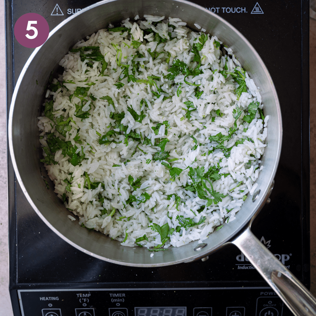 Cilantro mixed into white rice in a pot.