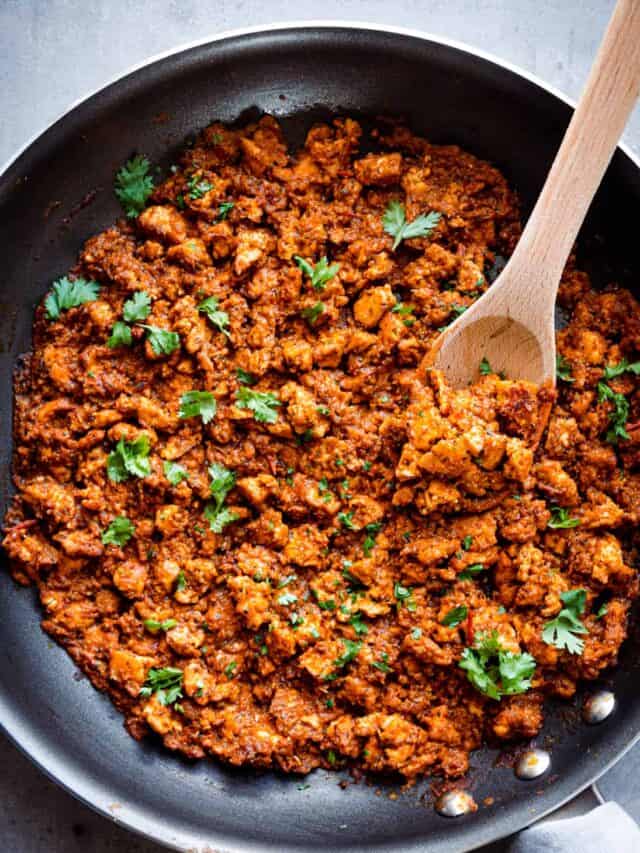 Overhead shot of Chipotle copycat sofritas and large wooden spoon in a frying pan.