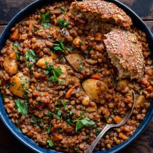 bowl of instant pot lentil soup with bread.