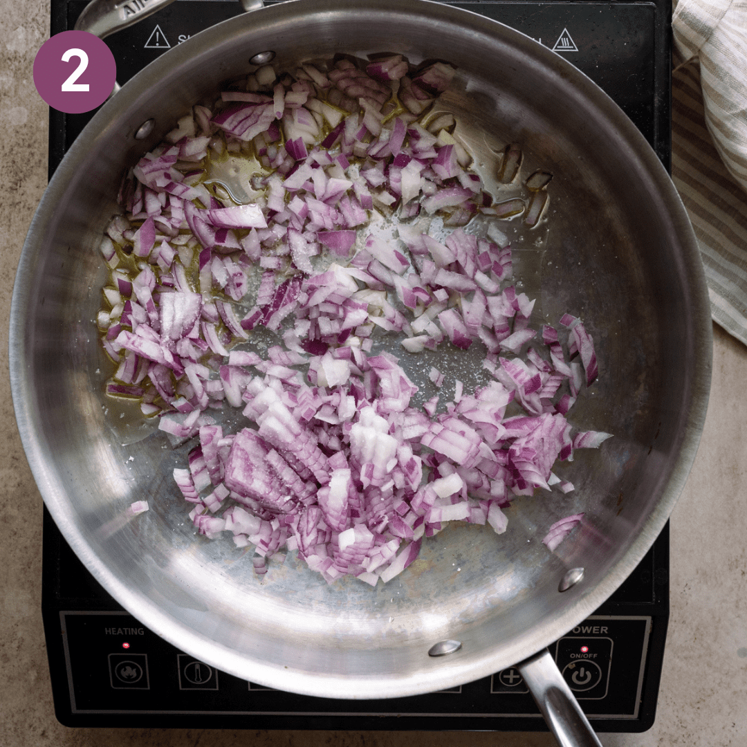 Onion and oil sautéing in a pan.