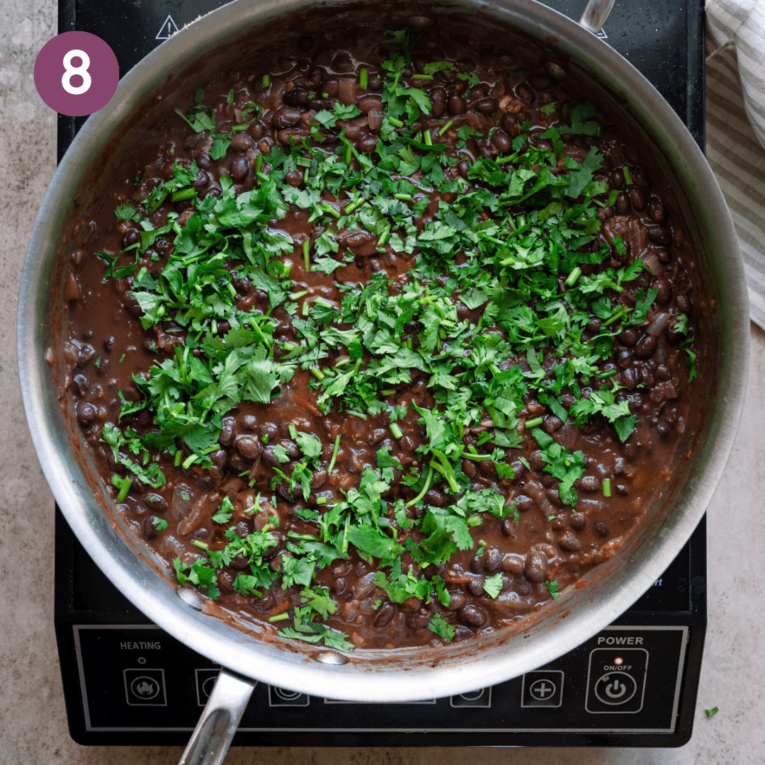 Olive oil, lime juice and cilantro added to black beans.