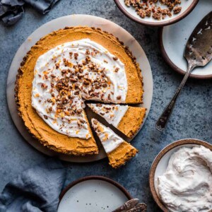 gingerbread pumpkin cream tart on a marble serving tray.