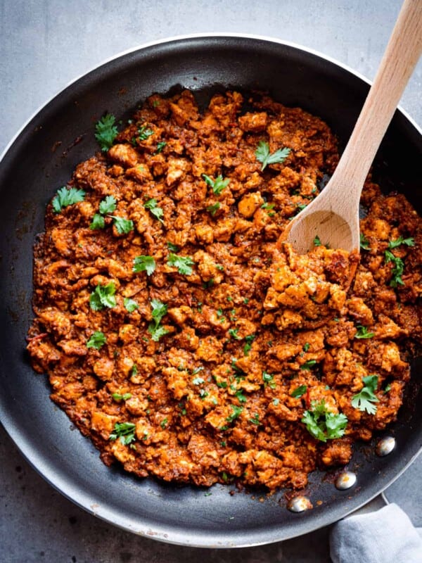 Overhead shot of Chipotle copycat sofritas and large wooden spoon in a frying pan.