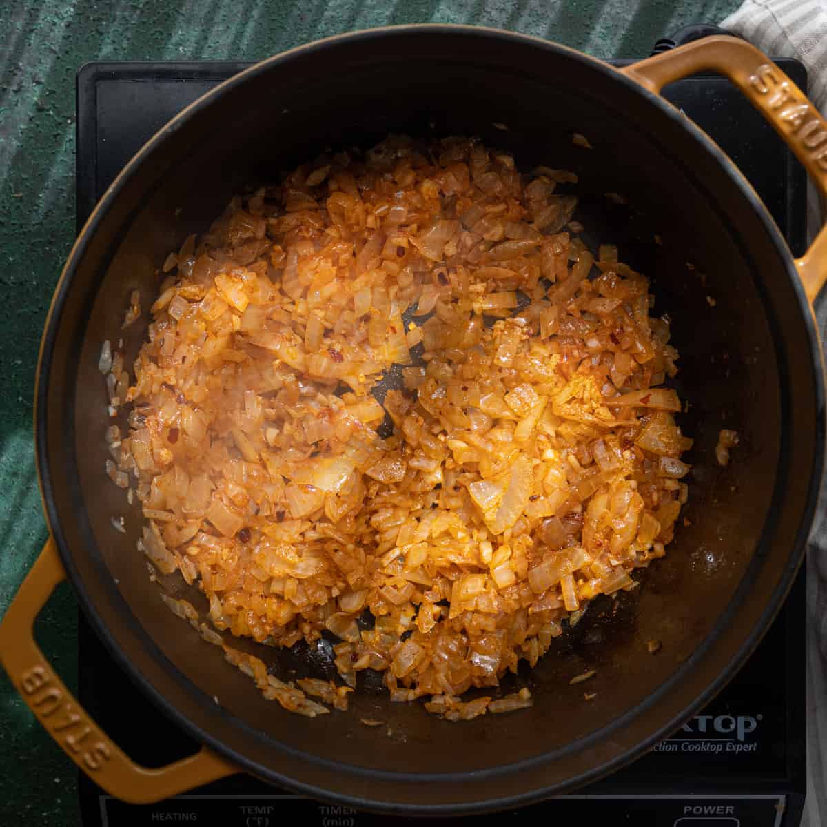 spices stirred into sauteed onions and garlic in a dutch oven. 
