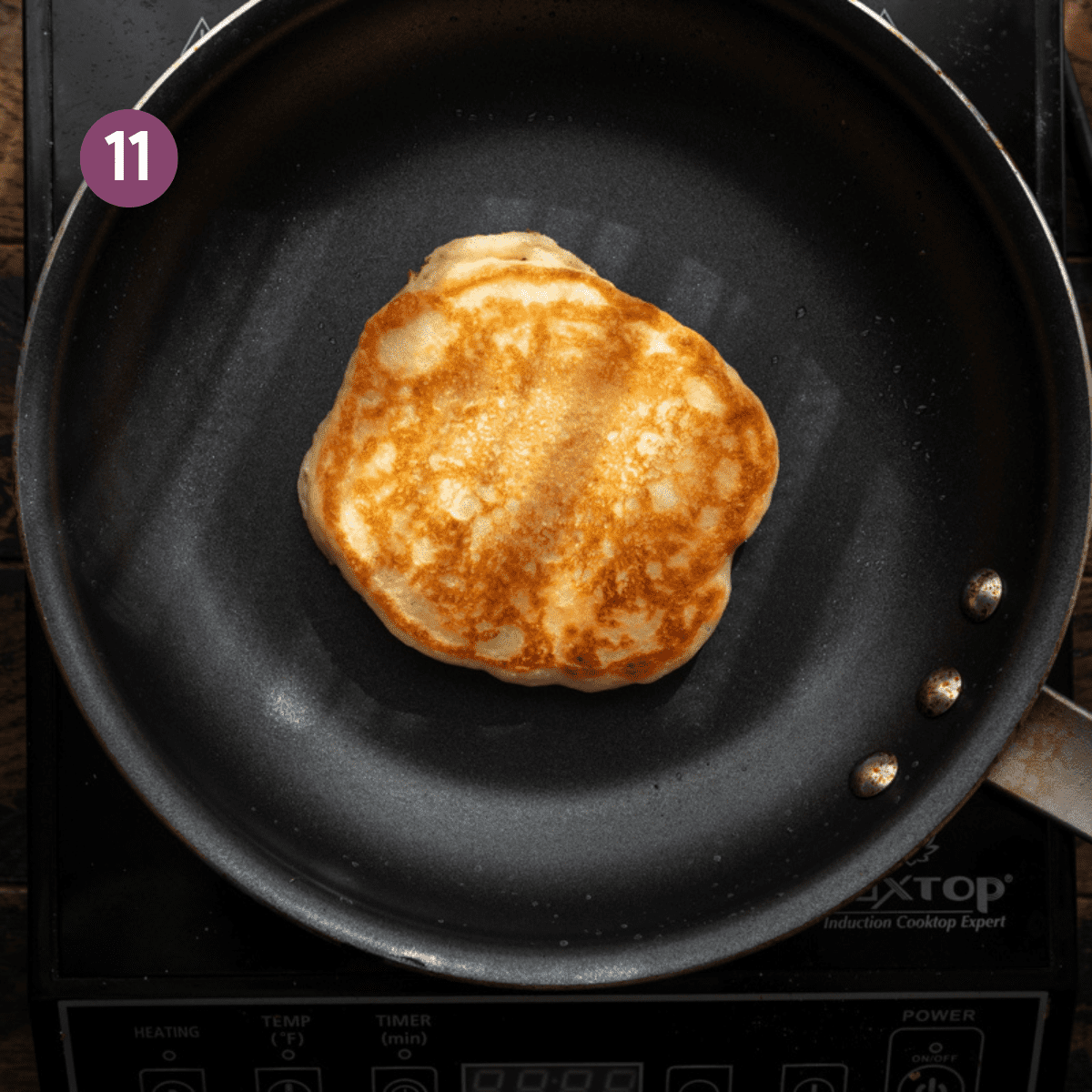 crispy browned vegan pancake in a black frying pan. 