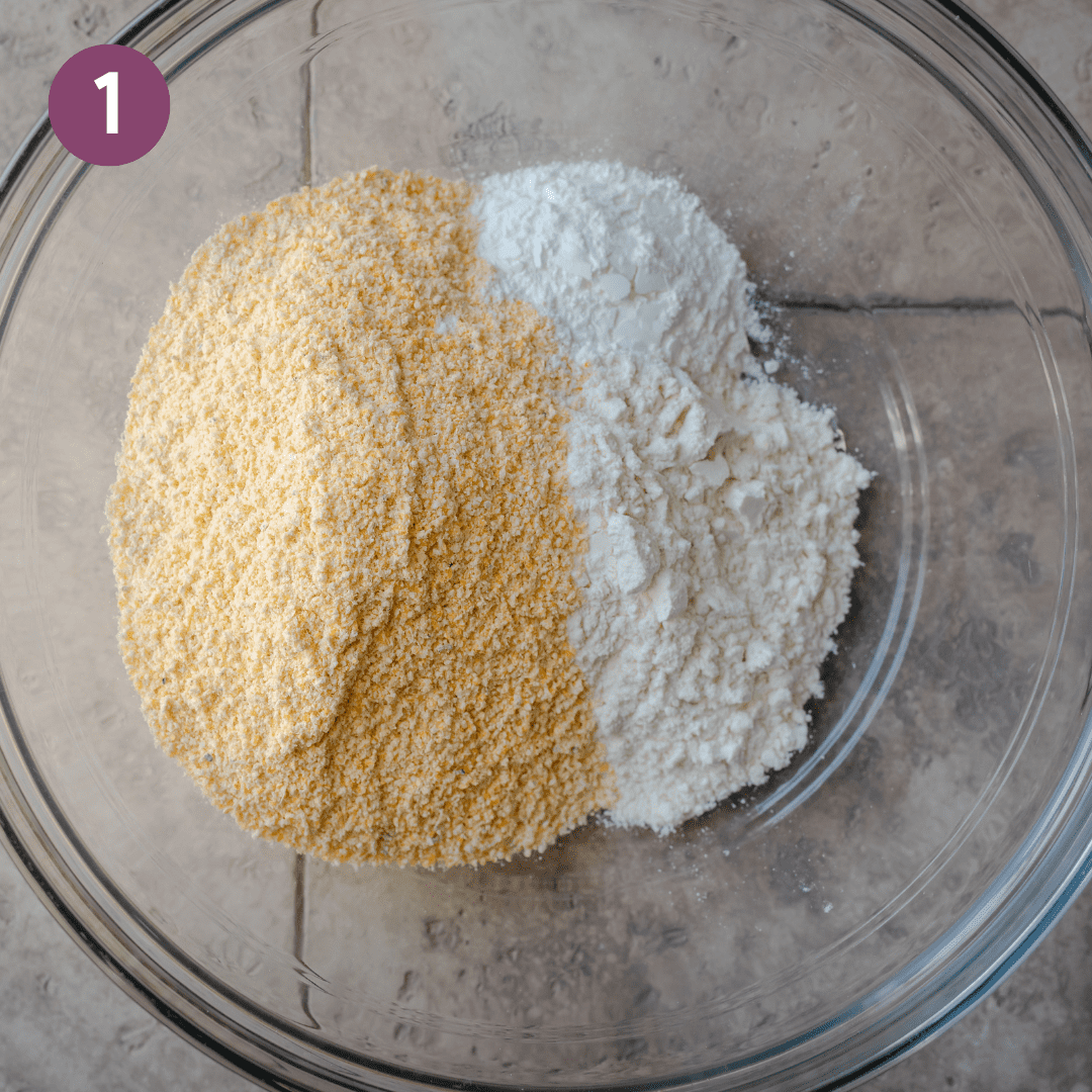 large glass bowl with cornmeal and flour side by side on a tiled surface. 