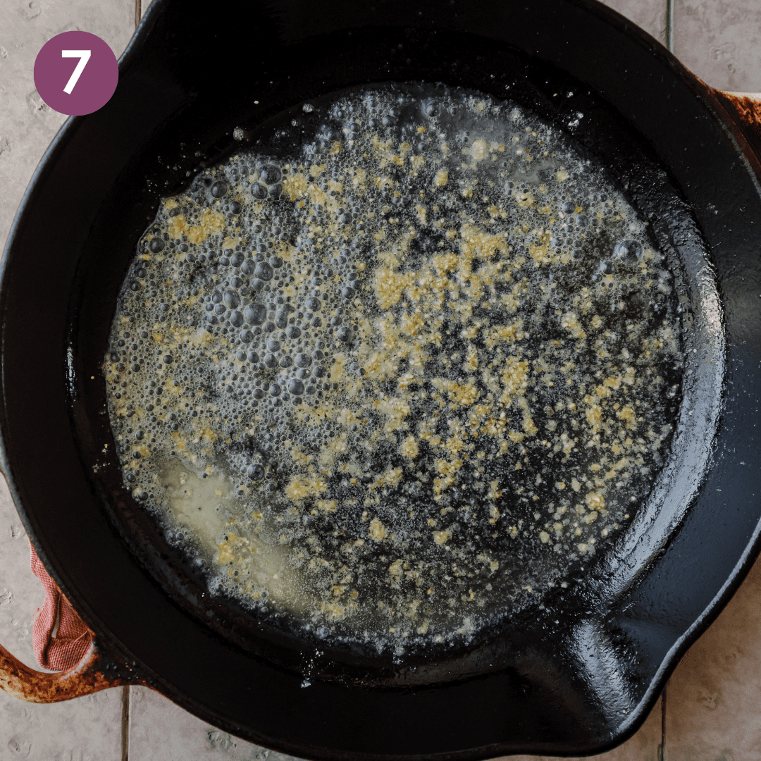 a dusting of cornmeal bits on top of melted vegan butter in a cast iron skillet.