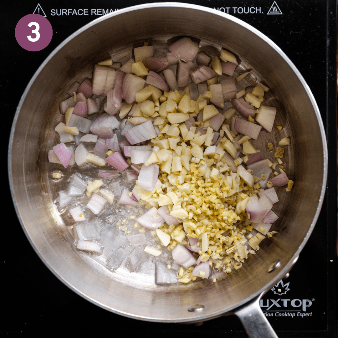 chopped shallots, ginger, garlic, and lemongrass in a sauteing in oil in a stainless steel saucepan.