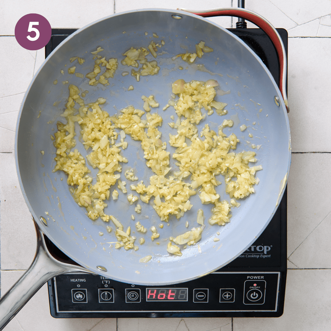 Shallots, garlic and butter frying in a pan.