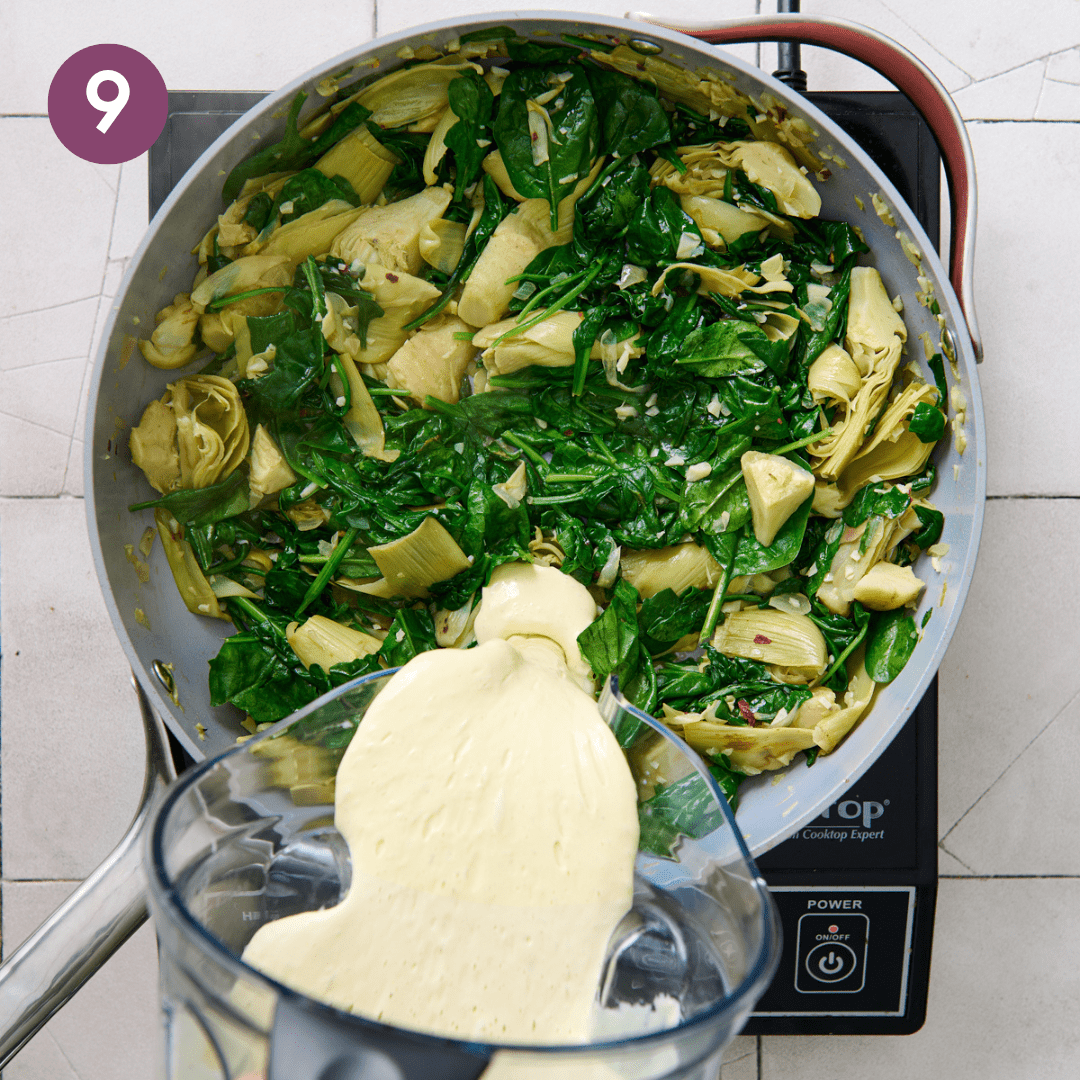 Woman pouring cashew cream into spinach artichoke mixture.